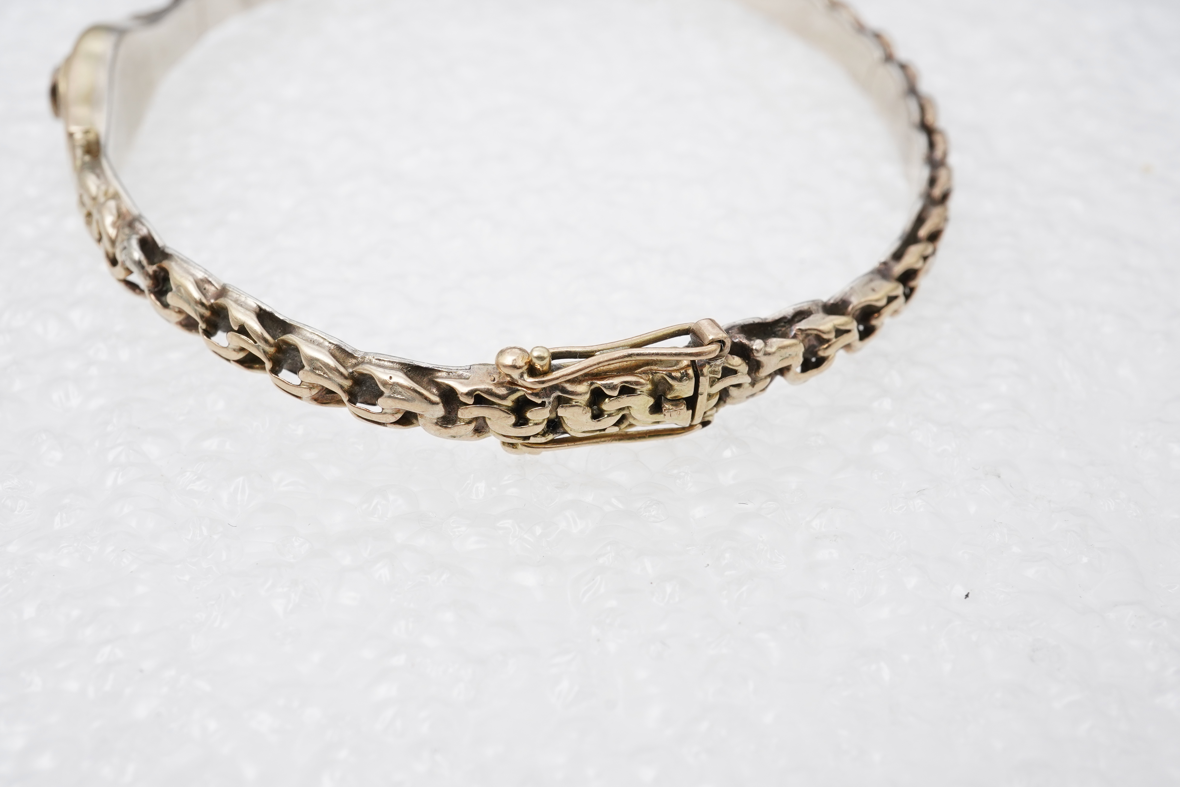 A collection of jewels and accessories, comprising: an onyx and diamond bar brooch, mounted in gold; a bangle set with a circular-cut diamond weighing approximately 0.07 carats, inner circumference approximately 17cm, st